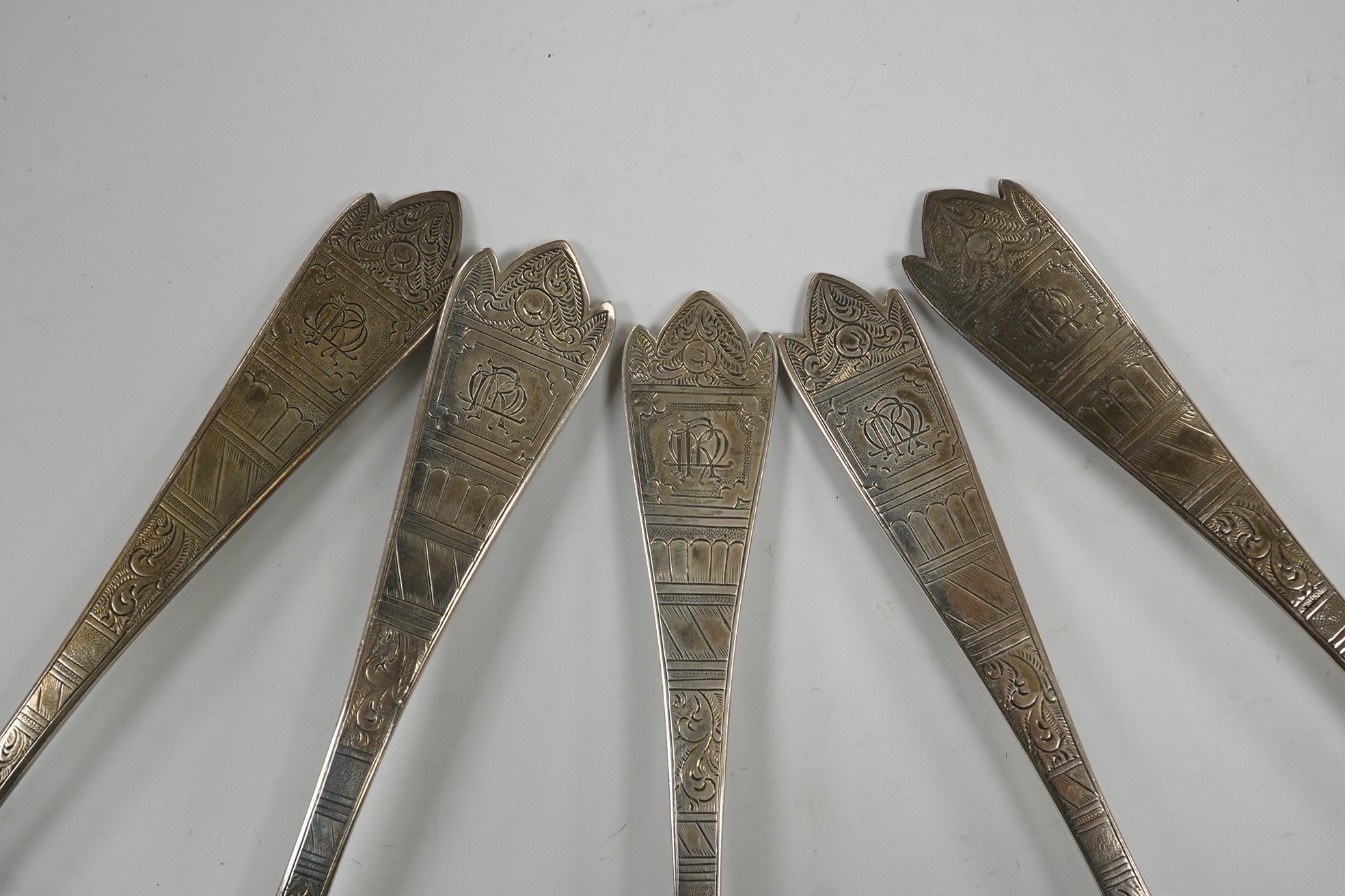 Five assorted George III and later serving spoons with later engraved decoration, earliest London, 1791, 16.8cm, 6.4oz. Condition - fair